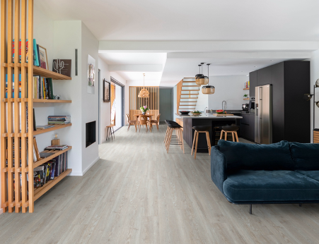 modern living area with kitchen, stairs and dining on vinyl floors