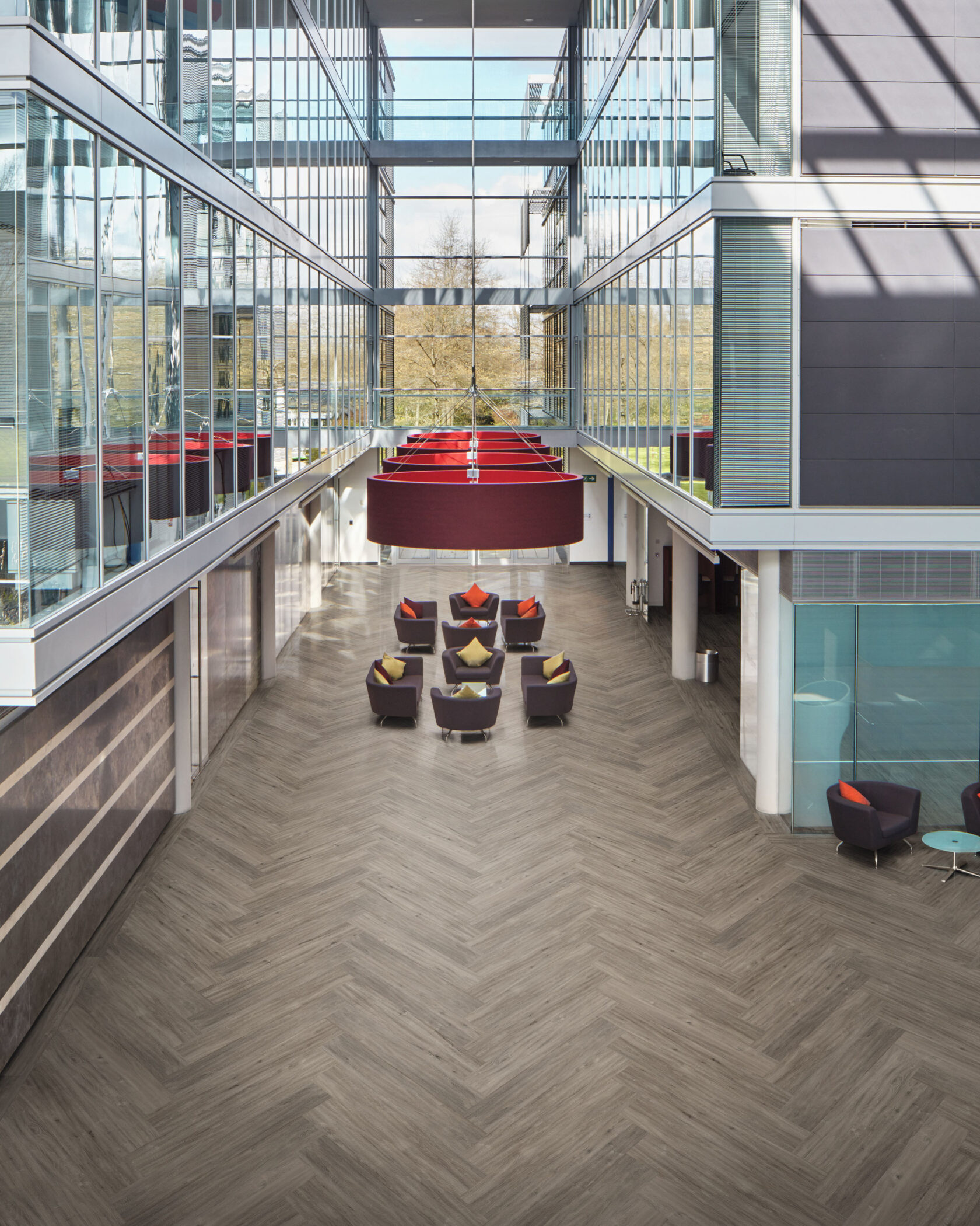 Herringbone Vinyl plank flooring in modern interior with large windows